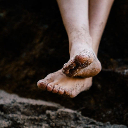 bare feet on beach sand